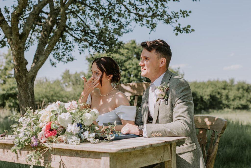Outdoor wedding ceremony in the orchard at The Secret Barn